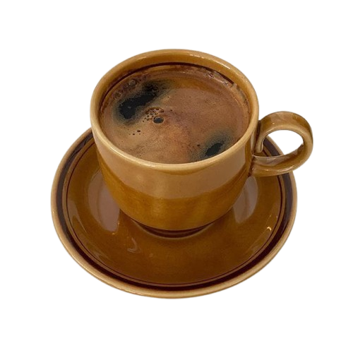 A brown ceramic cup on a saucer containing hot black coffee